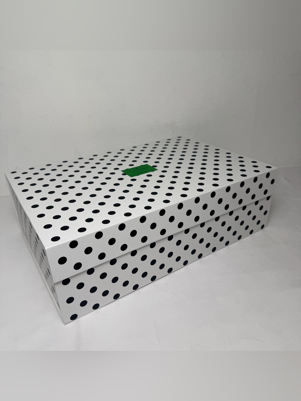 Kate Spade nesting box white/black polka dot pattern and a magnetic flap closure